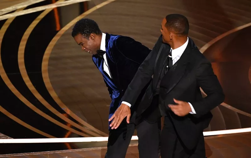 (FILES) In this file photo taken on March 27, 2022 US actor Will Smith (R) slaps US actor Chris Rock onstage during the 94th Oscars at the Dolby Theatre in Hollywood, California. - Chris Rock finally hit back at Will Smith on March 4, 2023 in a brutal stand-up routine, a year after the actor slapped him in front of a global TV audience for the Oscars. (Photo by Robyn Beck / AFP)
