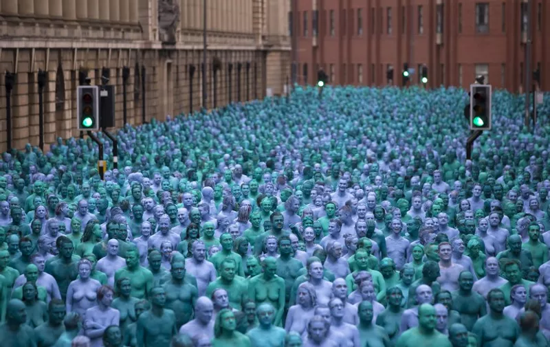 Naked volunteers, painted in blue to reflect the colours found in Marine paintings in Hull's Ferens Art Gallery, participate in US artist, Spencer Tunick's "Sea of Hull" installation in Kingston upon Hull on July 9, 2016.
Over a period of 20 years, the New York based artist has created over 90 art installations in some of the most culturally significant places and landmarks around the world including the Sydney Opera House, Place des Arts in Montreal, Mexico City, Ernest Happel Stadium in Vienna and Munich in Germany. / AFP PHOTO / JON SUPER / RESTRICTED TO EDITORIAL USE - MANDATORY MENTION OF THE ARTIST UPON PUBLICATION - TO ILLUSTRATE THE EVENT AS SPECIFIED IN THE CAPTION - NO CLOSE UP SHOTS TO BE REPRODUCED OF INDIVIDUALS INVOLVED IN THE INSTALLATION