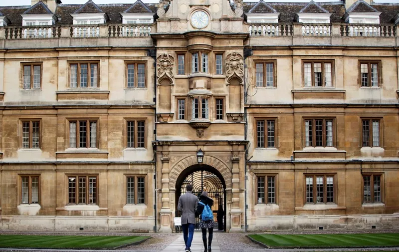 Students walk through Cambridge University in Cambridge, east of England, on March 14, 2018. (Photo by Tolga Akmen / AFP)