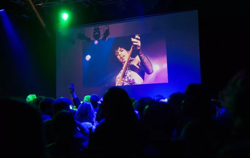 MINNEAPOLIS, MN - APRIL 21: Guests dance to Prince music as a slide show flashes images of the artist above the stage during a memorial dance party at the First Avenue nightclub on April 21, 2016 in Minneapolis, Minnesota. Prince, 57, was pronounced dead shortly after being found unresponsive at Paisley Park Studios in Chanhassen, Minnesota near Minneapolis.   Scott Olson/Getty Images/AFP