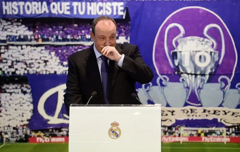 The new head-coach of Real Madrid football team, Rafael Benitez gets excited as he gives a press conference at the Santiago Bernabeu stadium in Madrid on June 3, 2015. The hiring of Rafael Benitez as Real Madrid boss today makes the Spaniard the 10th coach to serve under Florentino Perez during his two spells as the club's president between June 2000-February 2006 and since June 2009. AFP PHOTO / PIERRE-PHILIPPE MARCOU
