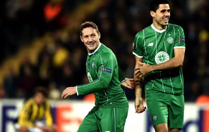 Celtic's Kris Commons (L) celebrates with his teammate Tom Rogic (R) after scoring during the UEFA Europa League football match between Fenerbahce and Celtic at Fenerbahce Sukru Saracoglu stadium in Istanbul on December 10, 2015.  / AFP / OZAN KOSE