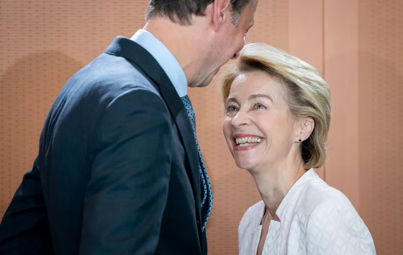 German Defence Minister Ursula von der Leyen shares a smile with Minister of State to the Federal Chancellor Hendrik Hoppenstedt as they arrive to attend the weekly cabinet meeting at Chancellery in Berlin on July 3, 2019. - After three days of bitter wrangling, German Defence Minister Ursula von der Leyen was named to replace Jean-Claude Juncker at the head of the European Commission for the next five years. (Photo by Kay Nietfeld / dpa / AFP) / Germany OUT