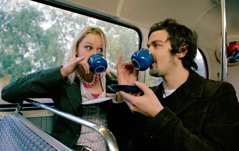 Couple drinking tea on bus (Photo by Jasper White / Image Source / Image Source via AFP)