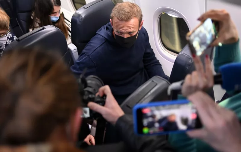 Russian opposition leader Alexei Navalny is seen in a Pobeda plane after it landed at Moscow's Sheremetyevo airport on January 17, 2021. - A flight carrying Kremlin critic Alexei Navalny back to Russia has landed in Moscow after it was diverted from a different airport where his supporters and media had gathered, AFP journalists on the plane said. The 44-year-old opposition figure risks imminent arrest. Russian police on Sunday already detained four of his top allies who had gathered at Vnukovo airport in Moscow, where he had been due to land, before the flight was diverted to Sheremetyevo. (Photo by Kirill KUDRYAVTSEV / AFP)