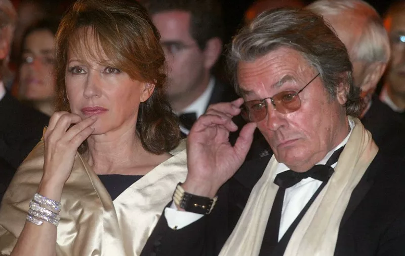 French actors Alain Delon and Nathalie Baye attend a ceremony in honor of French producer Daniel Toscan du Plantier 04 October 2003 at the Al Badii Palace in Marrakech during the third Marrakech Film Festival.