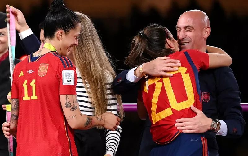 (FILES) Spain's defender #20 Rocio Galvez is congratuled by President of the Royal Spanish Football Federation Luis Rubiales (R) next to Spain's Jennifer Hermoso after winning the Australia and New Zealand 2023 Women's World Cup final football match between Spain and England at Stadium Australia in Sydney on August 20, 2023. Spanish football federation chief Luis Rubiales' apology for kissing star player Jenni Hermoso on the lips after Spain won the Women's World Cup is "insufficient" and his gesture "unacceptable" Spanish Prime Minister said on August 22, 2023. Rubiales, 45, kissed Hermoso as he handed the Spanish team gold medals after they beat England 1-0 in the final in Sydney, provoking outrage in Spain. (Photo by FRANCK FIFE / AFP)