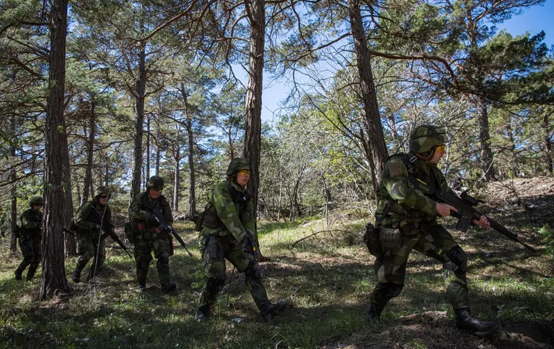 Swedish Home Guard soldiers take part in a field exercise near Visby on the Swedish island of Gotland on May 17, 2022. - Finland and Sweden are expected to announce this week whether to apply to join NATO following Russia's Ukraine invasion, in what would be a stunning reversal of decades-long non-alignment policies. On Sweden's strategically-located Baltic Sea island of Gotland, Home Guard troops were last week called in for a special month-long training exercise, coinciding with annual military exercises taking place across Finland and Sweden next week. (Photo by Jonathan NACKSTRAND / AFP)