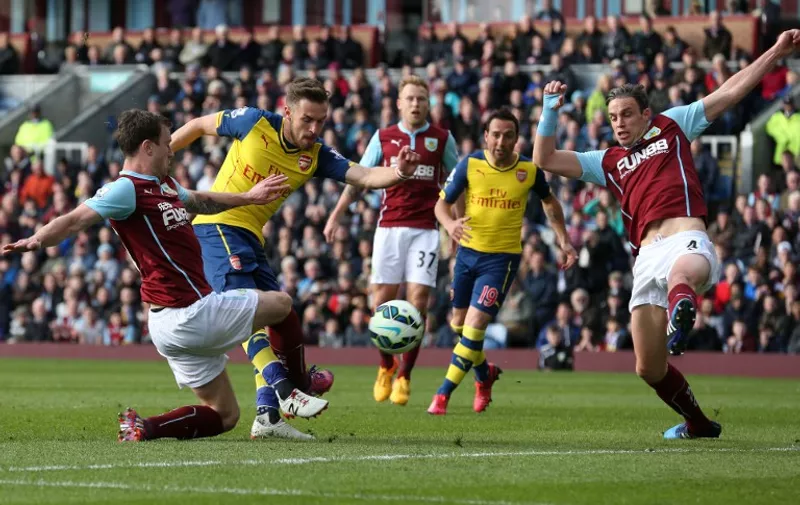 Arsenal&#8217;s Welsh midfielder Aaron Ramsey (2L) scores the opening goal against Burnley during the English Premier League football match between Burnley and Arsenal at Turf Moor in Burnley, north west England, on April 11, 2015. AFP PHOTO / LINDSEY PARNABY RESTRICTED TO EDITORIAL USE. No use with unauthorized audio, video, data, fixture lists, club/league logos [&hellip;]