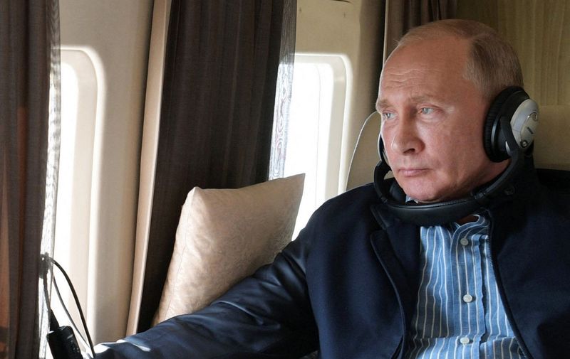 Russian President Vladimir Putin sits aboard a helicopter on his way to the Rassvet agricultural company outside Stavropol on October 9, 2018. (Photo by Alexey DRUZHININ / Sputnik / AFP)