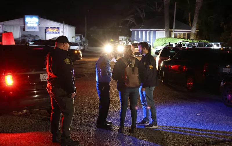HALF MOON BAY, CALIFORNIA - JANUARY 23: A San Mateo County sheriff deputy checks in FBI agents as they arrive at the scene of a shooting on January 23, 2023 in Half Moon Bay, California. Seven people were killed at two separate farm locations that were only a few miles apart in Half Moon Bay on Monday afternoon. The suspect, Chunli Zhao, was taken into custody a few hours later without incident.   Justin Sullivan/Getty Images/AFP (Photo by JUSTIN SULLIVAN / GETTY IMAGES NORTH AMERICA / Getty Images via AFP)