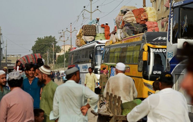 Pakistan's Afghan refugees load their belongings onto a bus at the Karachi bus terminal in Sindh province for their departure to Afghanistan on October 27, 2023. Islamabad has given Afghans it has deemed to be living illegally in Pakistan until November 1 to leave voluntarily or face deportation -- an order the Taliban government says amounts to harassment. The order comes as Pakistan grapples with a rise in attacks the government blames on militants operating from Afghanistan, a charge Kabul routinely denies. (Photo by Rizwan TABASSUM / AFP)
