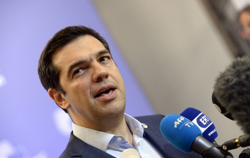 Greek Prime Minister Alexis Tsipras speaks to the press at the end of an Eurozone Summit over the Greek debt crisis in Brussels on July 13, 2015. Juncker said there was no longer any risk of Greece crashing out of the euro after Athens agreed a bailout deal with eurozone partners.  AFP PHOTO / THIERRY CHARLIER
