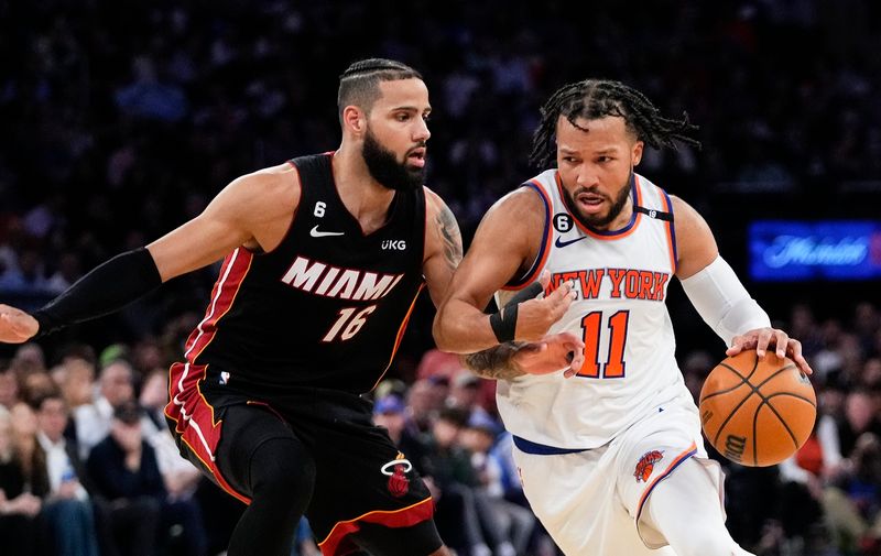 New York Knicks' Jalen Brunson (11) drives against Miami Heat's Caleb Martin (16) during the second half of Game 5 of an NBA basketball Eastern Conference playoff semifinal Wednesday, May 10, 2023, in New York. The Knicks won 112-103. (AP Photo/Frank Franklin II)