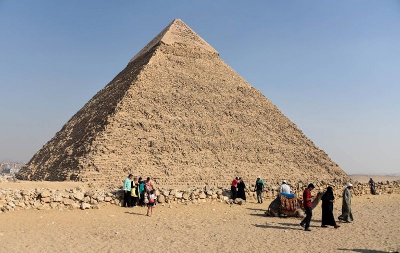 Tourists visit the Giza pyramids, on the southern outskirts of the Egyptian capital, Cairo, on September 27, 2015. AFP PHOTO / MOHAMED EL-SHAHED
