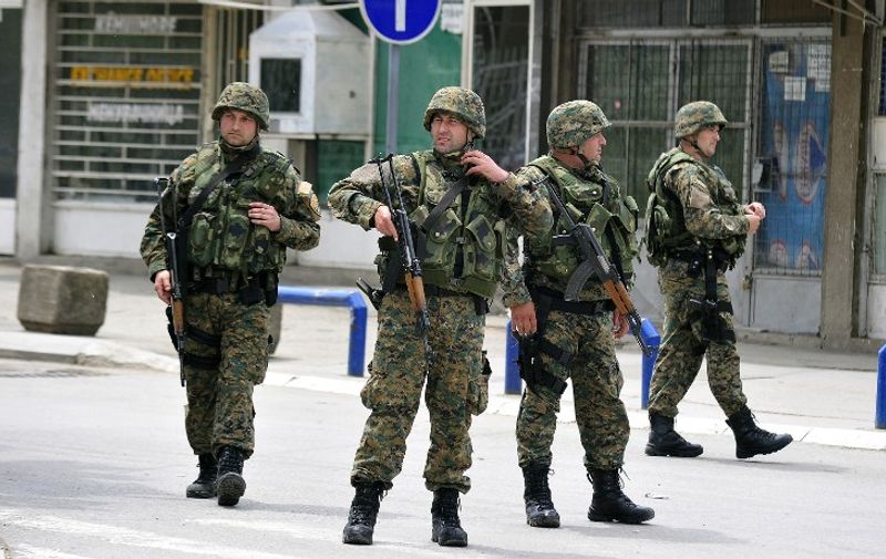 Armed police patrol in the conflict zone in the northern Macedonian town of Kumanovo on May 10, 2015. A policeman injured in clashes with unidentified gunmen in northern Macedonia died of his wounds on May 9 a hospital source said, raising the number of officers killed in the violence to six, along with some 30 injured in clashes with unidentified gunmen in Kumanovo that erupted on May 9 at dawn. Local media suggested the assailants came from neighbouring Kosovo, populated mostly by ethnic Albanians. AFP PHOTO / TOMISLAV GEORGIEV
