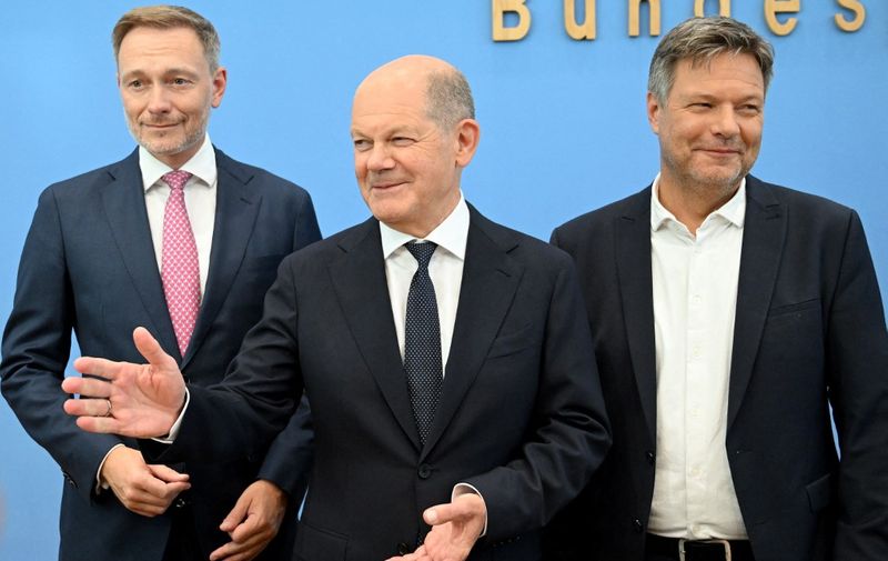 (L-R) German Finance Minister Christian Lindner, German Chancellor Olaf Scholz and German Minister of Economics and Climate Protection Robert Habeck arrive to deliver a press conference on July 5, 2024 in Berlin, after the three parties in Germany's ruling coalition struck an agreement on the 2025 budget after weeks of tough talks that pushed Chancellor's government to the brink of collapse. (Photo by RALF HIRSCHBERGER / AFP)