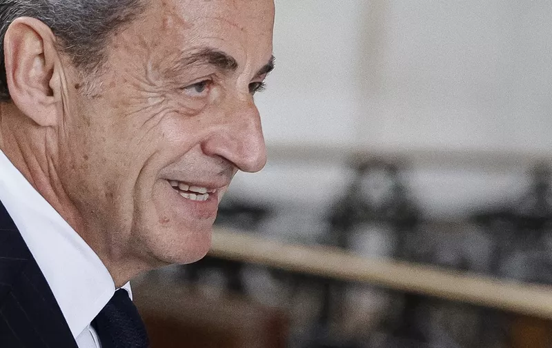 France's former president Nicolas Sarkozy arrives at the judicial court for questioning during the appeal trial in the so-called Bygmalion case, which saw him sentenced to one year in prison, in Paris on November 24, 2023. France's former President Nicolas Sarkozy and 13 others are accused of setting up or benefiting from a fake billing scheme to cover millions of euros in excess spending on campaign rallies. (Photo by Geoffroy VAN DER HASSELT / AFP)