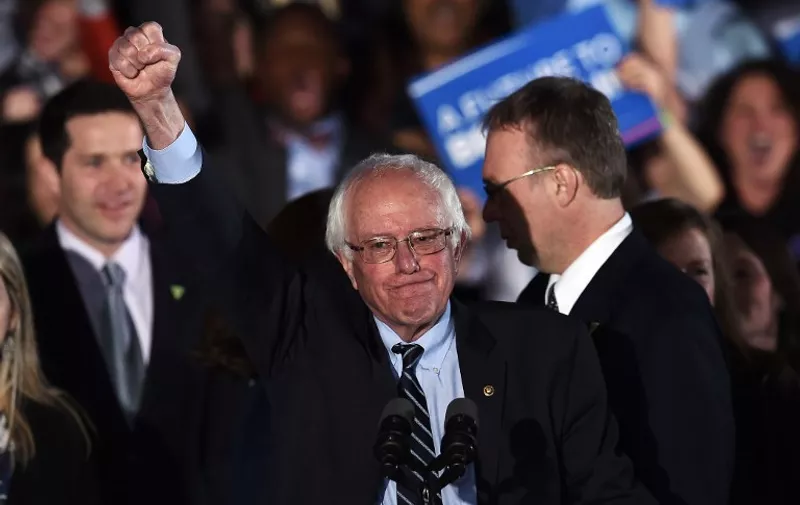 US Democratic presidential candidate Bernie Sanders celebrates his victory during the primary night rally in Concord, New Hampshire, on February 9, 2016.
Self-described democratic socialist Bernie Sanders and political novice Donald Trump won New Hampshire's presidential primaries Tuesday, US media projected, turning the American political establishment on its head early in the long nominations battle. / AFP / Jewel Samad