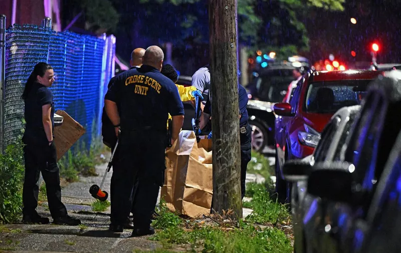 uPHILADELPHIA, PENNSYLVANIA - JULY 3: Police place a rifle in a bag on the scene of a shooting on July 3, 2023 in Philadelphia, Pennsylvania. Early reports say the suspect is in custody after shooting 8 people in the Kingsessing section of Philadelphia on July 3rd.   Drew Hallowell/Getty Images/AFP (Photo by Drew Hallowell / GETTY IMAGES NORTH AMERICA / Getty Images via AFP)