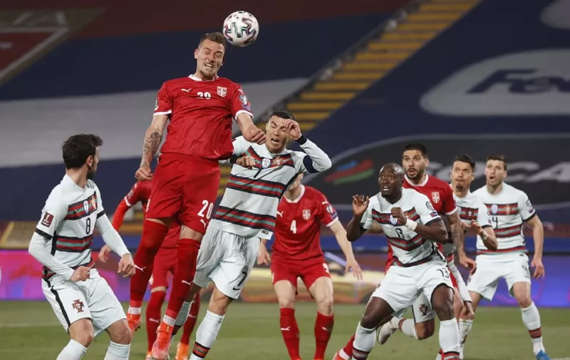 Serbia's midfielder Sergej Milinkovic-Savic (2ndL) heads the ball during the FIFA World Cup Qatar 2022 qualification Group A football match between Serbia and Portugal at the Rajko Mitic Stadium, in Belgrade, on March 27, 2021. (Photo by Pedja MILOSAVLJEVIC / AFP)