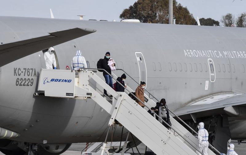 This photo taken and handout on February 3, 2020 by the Italian Defence Ministry Press Office shows Italian citizens repatriated from the coronavirus hot-zone of Wuhan exit an Italian Boeing KC-767 military aerial refueling and strategic transport aircraft, after landing at the Mario De Bernardi military airport in Pratica di Mare, south of Rome, to be placed in quarantine at the nearby Cecchignola center., Image: 496216604, License: Rights-managed, Restrictions: RESTRICTED TO EDITORIAL USE - MANDATORY CREDIT "AFP PHOTO / ITALIAN DEFENCE MINISTRY PRESS OFFICE " - NO MARKETING NO ADVERTISING CAMPAIGNS - DISTRIBUTED AS A SERVICE TO CLIENTS ---, Model Release: no, Credit line: Handout / AFP / Profimedia