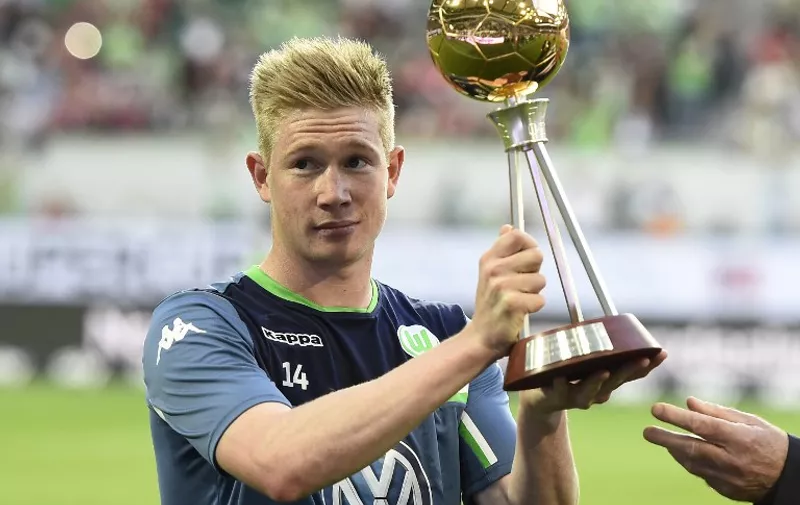 Wolfsburg's Belgian midfielder Kevin De Bruyne holds his trophy for "Best Player of The year" awarded by German sports journalists ahead of the German Supercup football match VfL Wolfsburg vs Bayern Munich in Wolfsburg, central Germany, on August 1, 2015. AFP PHOTO / TOBIAS SCHWARZ

DFL RULES TO LIMIT THE ONLINE USAGE DURING MATCH TIME TO 15 PICTURES PER MATCH. IMAGE SEQUENCES TO SIMULATE VIDEO IS NOT ALLOWED AT ANY TIME. FOR FURTHER QUERIES PLEASE CONTACT DFL DIRECTLY AT + 49 69 650050.