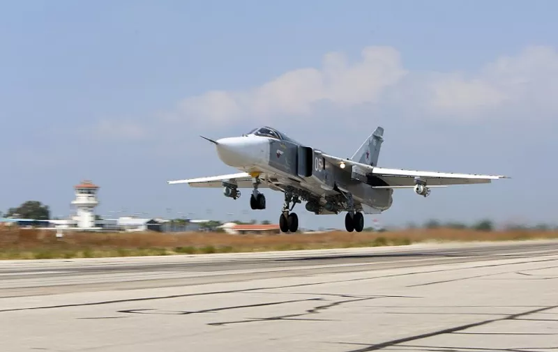 A picture taken on October 3, 2015 shows a Russian Sukhoi Su-24 bomber taking off from the Hmeimim airbase in the Syrian province of Latakia. AFP PHOTO / KOMSOMOLSKAYA PRAVDA / ALEXANDER KOTS
*RUSSIA OUT*