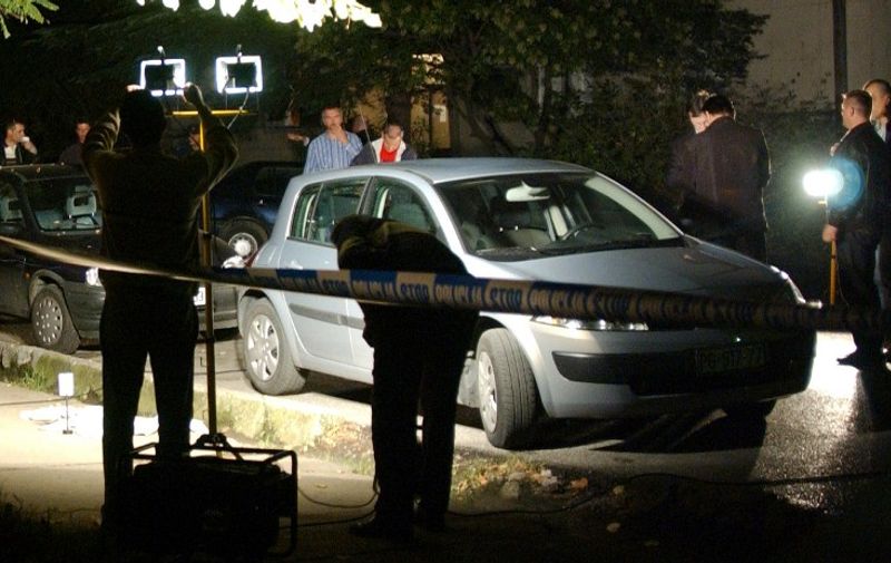 Police officers investigate the scene where Montenegrin novelist Jevrem Brkovic was injured during an attack by three men near his home late 24 October 2006, in Podgorica. Brokvic's bodyguard was shot dead in the attack.   AFP PHOTO / SAVO PRELEVIC
