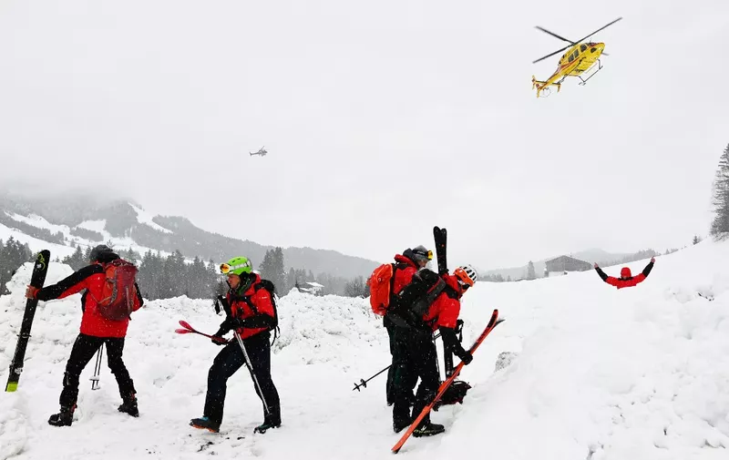 A photo taken on February 4, 2023 shows rescuers during their mission near Fieberbrunn, western Austria. Avalanches in Austria and Switzerland have left five people dead, leading officials to warn on February 4 of the risks posed by particularly unstable snow cover. Three of those killed were visiting Austria's Alpine regions. In Fieberbrunn (Kitzbühel district), two people with injuries were transported to the valley after an avalanche. (Photo by ZOOM.TIROL / APA / AFP) / Austria OUT