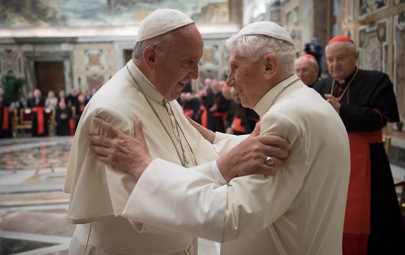 This handout picture released by the Vatican press office shows Pope Francis (L) during a celebration to mark the 65th anniversary of the ordination of Pope Emeritus Benedict XVI (R) on June 28, 2016 at the Vatican. - Three years after he became the first pope to retire in seven centuries, the 89-year-old German confounded rumours that his health was failing by standing for nearly ten minutes as he spoke in a clearly audible, steady voice in a mixture of Italian and Latin. (Photo by HO / OSSERVATORE ROMANO / AFP) / RESTRICTED TO EDITORIAL USE - MANDATORY CREDIT "AFP PHOTO / OSSERVATORE ROMANO" - NO MARKETING NO ADVERTISING CAMPAIGNS - DISTRIBUTED AS A SERVICE TO CLIENTS