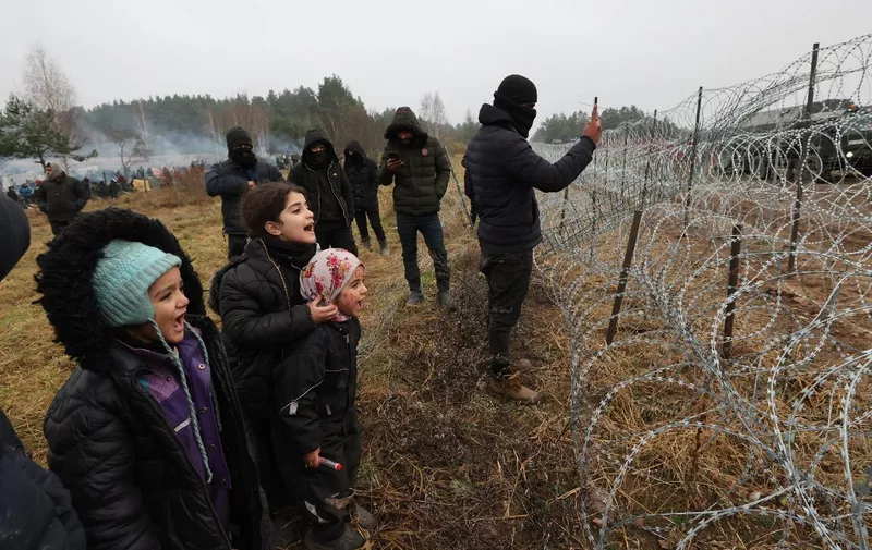 Migrants aiming to cross into Poland camp near the Bruzgi-Kuznica border crossing on the Belarusian-Polish border on November 17, 2021. (Photo by Maxim GUCHEK / BELTA / AFP) / Belarus OUT