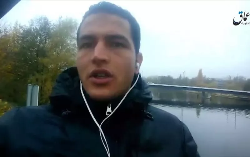 An image grab taken from a propaganda video bearing the logo of Islamic state group - linked Amaq News Agency (top R), and released on a crypted website on December 23, 2016 shows Anis Amri, the prime suspect in the Berlin Christmas market attack, pledging allegiance to the IS.
The video allegedly taken on the Kieler Bruecke, a Berlin bridge, shows Tunisian Anis Amri, who was killed on December 23 in a shootout with Italian police in Milan, ending a massive European manhunt. / AFP PHOTO / AMAQ NEWS AGENCY / - / RESTRICTED TO EDITORIAL USE - MANDATORY CREDIT "AFP PHOTO / HO / AAMAQ NEWS AGENCY" - NO MARKETING NO ADVERTISING CAMPAIGNS - DISTRIBUTED AS A SERVICE TO CLIENTS FROM ALTERNATIVE SOURCES, AFP IS NOT RESPONSIBLE FOR ANY DIGITAL ALTERATIONS TO THE PICTURE'S EDITORIAL CONTENT, DATE AND LOCATION WHICH CANNOT BE INDEPENDENTLY VERIFIE /