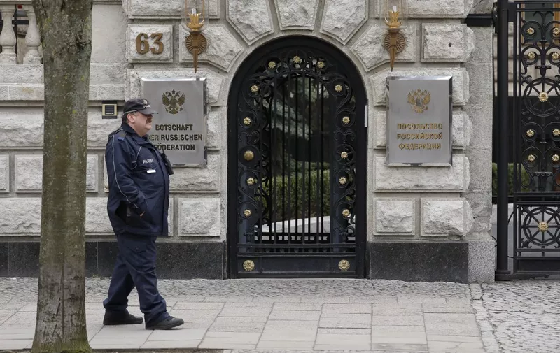 A policeman walks in front of the Russian embassy in Berlin on March 26, 2018. - Germany's foreign minister said Berlin had ordered the expulsion of four Russian diplomats over the poisoning of a former spy in England, as EU nations step up the pressure on Moscow. (Photo by Odd ANDERSEN / AFP)