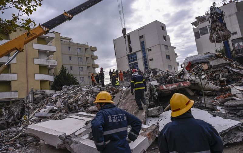 Rescue teams and firefighters search for survivors stuck on a collapsed building in the town of Durres on November 28, 2019, after the strongest earthquake in decades claimed at least 20 lives, with victims trapped in the debris of toppled buildings. - Albanian rescuers dug through rubble as desperate survivors trapped in toppled buildings cried out for help on November 26, 2019, after the strongest earthquake in decades killed at least 16 people and left hundreds injured. The 6.4 magnitude quake struck before dawn at 3:54 am local time (0254 GMT), with an epicentre 34 kilometres (about 20 miles) northwest of the capital Tirana, according to the European-Mediterranean Seismological Centre. (Photo by Armend NIMANI / AFP)