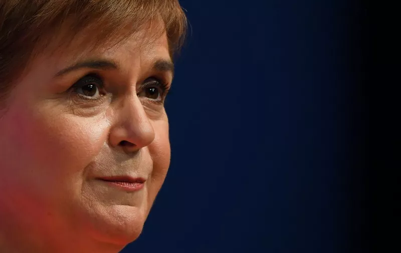 (FILES) Scotland's First Minister and leader of the Scottish National Party (SNP), Nicola Sturgeon, reacts as she delivers her speech to delegates at the annual SNP Conference in Aberdeen, Scotland, on October 10, 2022. Former Scottish leader Nicola Sturgeon was  arrested on June 11, 2023 as part of an investigation into financial irregularities, according to police and UK media. "A 52-year-old woman has today... been arrested as a suspect in connection with the ongoing investigation into the funding and finances of the Scottish National Party," Police Scotland said in a statement, with British media confirming her identity as Sturgeon. (Photo by ANDY BUCHANAN / AFP)
