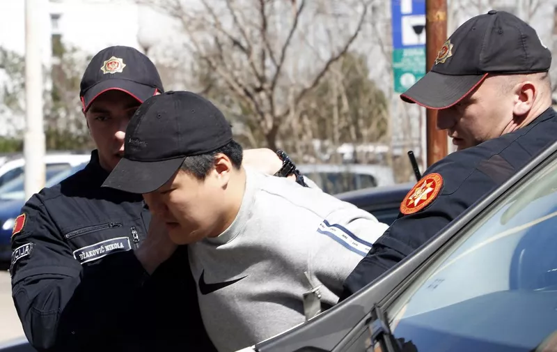 South Korean cryptocurrency entrepreneur co-founder of Terraform Labs (Terra Luna), Do Kwon (C) is taken to court after being arrested at the airport on March 24, 2023 in Podgorica. - Montenegro charged fugitive cryptocurrency entrepreneur Do Kwon with forgery, with the South Korean expected to appear in court for extradition proceedings. Kwon, through his company Terraform Labs,is accused of orchestrating a multi-billion-dollar fraud that shook global crypto markets last year. (Photo by STRINGER / AFP)