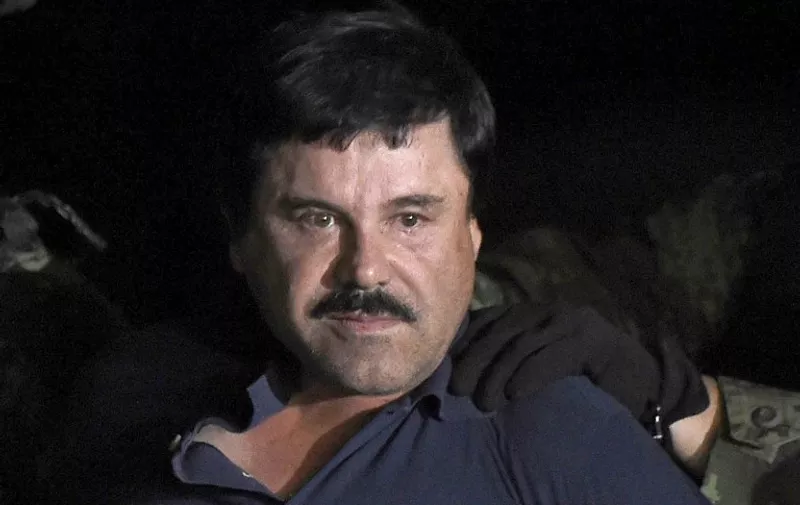 Drug kingpin Joaquin "El Chapo" Guzman is escorted into a helicopter at Mexico City's airport on January 8, 2016 following his recapture during an intense military operation in Los Mochis, in Sinaloa State. Mexican marines recaptured fugitive drug kingpin Joaquin "El Chapo" Guzman on Friday in the northwest of the country, six months after his spectacular prison break embarrassed authorities.   AFP PHOTO / ALFREDO ESTRELLA / AFP / ALFREDO ESTRELLA