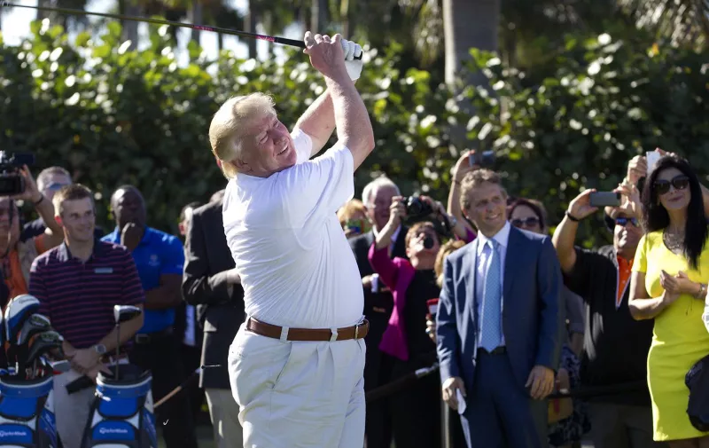 Donald Trump shows off his updated golf course by hitting a ceremonial tee shot off the first tee at Trump National Doral, Feb. 6, 2014, in Doral, Fla. Doral City Council members will discuss a proposed resolution Tuesday to have Trump's golf resort reassessed. (David Walters/Miami Herald/TNS)