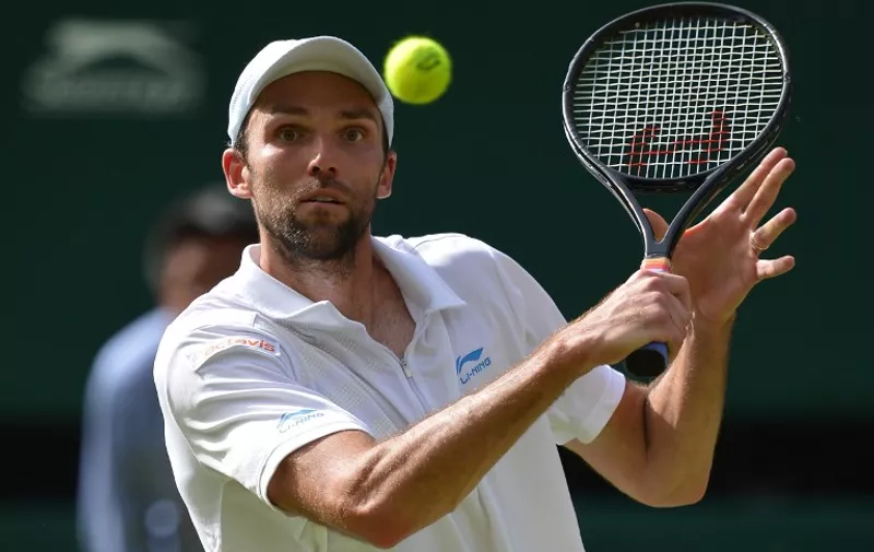 Croatia's Ivo Karlovic plays a shot during his second round men's singles match against Britain's Andy Murray on day four of the 2012 Wimbledon Championships tennis tournament at the All England Tennis Club in Wimbledon, southwest London, on June 28, 2012. RESTRICTED TO EDITORIAL USE