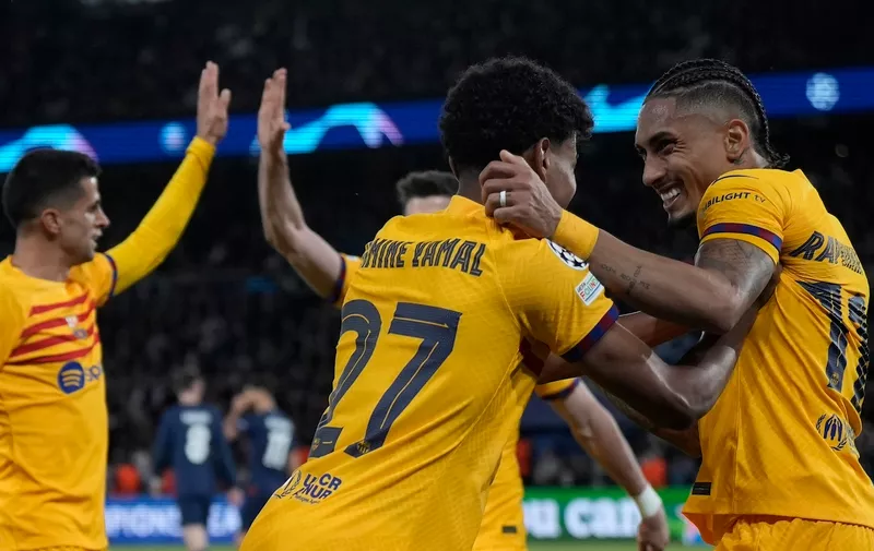 Barcelona's Raphinha, right, celebrates with his teammates after scoring his side's opening goal during the Champions League quarterfinal first leg soccer match between Paris Saint-Germain and Barcelona at the Parc des Princes stadium in Paris, Wednesday, April 10, 2024. (AP Photo/Lewis Joly)