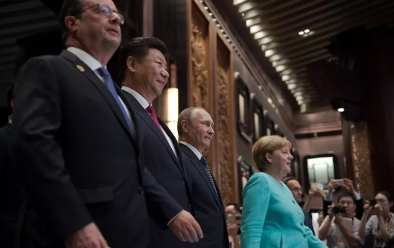 (L to R) French President Francois Hollande, Chinese President Xi Jinping, Russia's President Vladimir Putin and German Chancellor Angela Merkel arrive for the opening ceremony of the G20 Leaders Summit in Hangzhou on September 4, 2016.
G20 leaders confront a sluggish global economy and the winds of populism as they open annual talks, but the long war in Syria and the South China Sea territorial dispute hang over the summit. / AFP PHOTO / NICOLAS ASFOURI