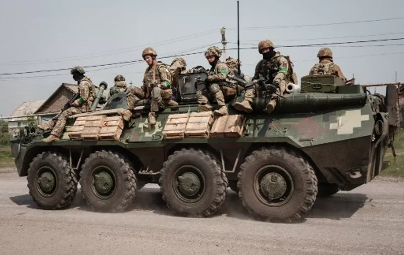 Ukrainian soldiers sit on an armoured Personnel Carrier (APC) in Seversk, eastern Ukraine, on May 8, 2022, amid the Russian invasion of Ukraine. (Photo by Yasuyoshi CHIBA / AFP)