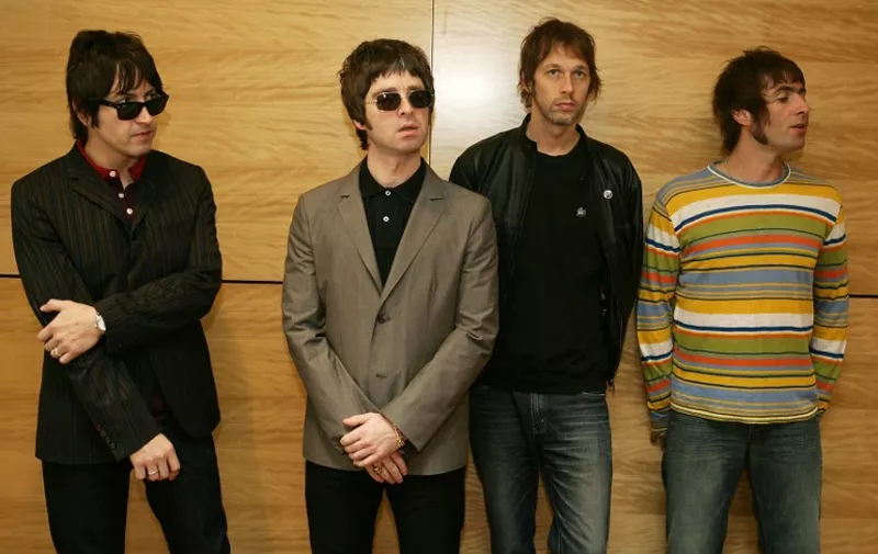 From L-R Gem, Noel Gallagher, Andy Bell and Liam Gallagher, members of the British rock band "Oasis" hold a photocall in Hong Kong 25 February 2006.  The Band are to hold a concert 25 February.      AFP PHOTO/MIKE CLARKE / AFP PHOTO / MIKE CLARKE