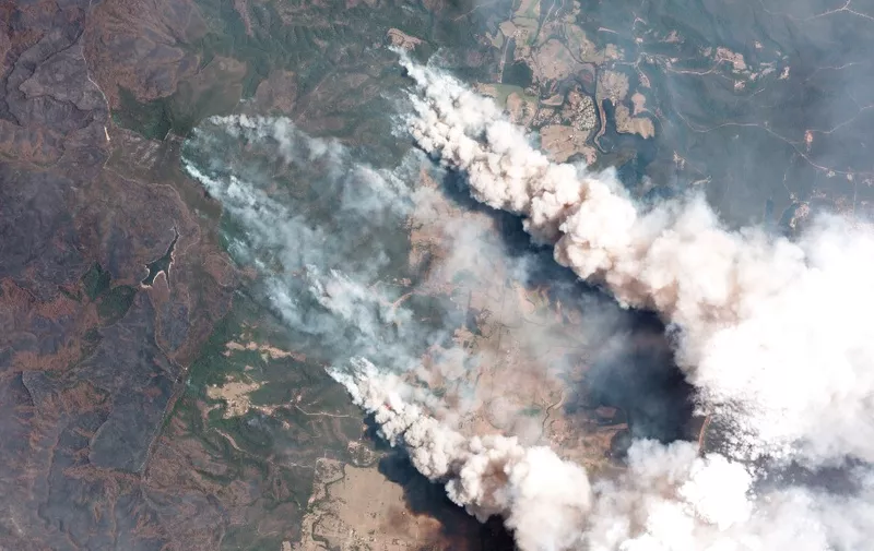 This handout satellite image taken on December 31, 2019 and received from Planet Labs, Inc. on January 7, 2020 shows smoking rising into the air from bushfires near Lake Conjolia in the Australian state of New South Wales. - Firefighters raced to contain massive bushfires in southeastern Australia on January 7, taking advantage of a brief drop in temperatures and some much-needed rainfall before another heatwave strikes later this week. (Photo by Handout / 2019 Planet Labs, Inc. / AFP) / -----EDITORS NOTE --- RESTRICTED TO EDITORIAL USE - MANDATORY CREDIT "AFP PHOTO / 2019 Planet Labs, Inc." - NO MARKETING - NO ADVERTISING CAMPAIGNS - DISTRIBUTED AS A SERVICE TO CLIENTS  - NO ARCHIVES