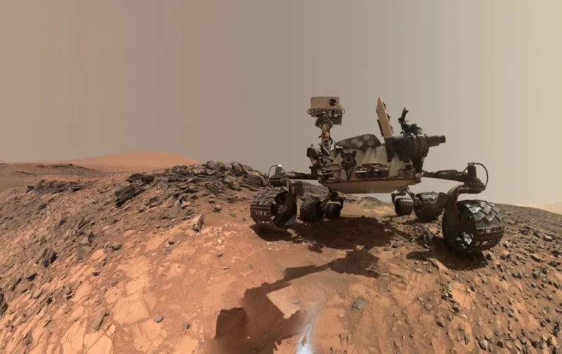This NASA photo released June 7, 2018 shows a low-angle self-portrait of NASA's Curiosity Mars rover vehicle at the site from which it reached down to drill into a rock target called "Buckskin" on lower Mount Sharp. - NASAs Curiosity rover has found new evidence preserved in rocks on Mars that suggests the planet could have supported ancient life, as well as new evidence in the Martian atmosphere that relates to the search for current life on the Red Planet. While not necessarily evidence of life itself, these findings are a good sign for future missions exploring the planets surface and subsurface. The new findings  tough organic molecules in three-billion-year-old sedimentary rocks near the surface, as well as seasonal variations in the levels of methane in the atmosphere  appear in the June 8, 2018 edition of the journal Science. (Photo by Handout / NASA / AFP) / RESTRICTED TO EDITORIAL USE - MANDATORY CREDIT "AFP PHOTO / NASA" - NO MARKETING NO ADVERTISING CAMPAIGNS - DISTRIBUTED AS A SERVICE TO CLIENTS