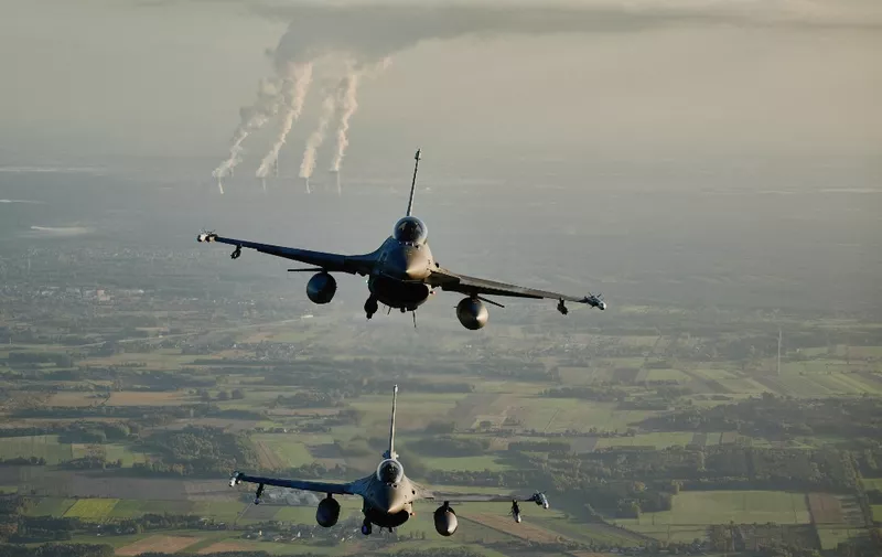 F 16 fighter jets takes part in the NATO Air Shielding exercise near the air base in Lask, central Poland on October 12, 2022. (Photo by RADOSLAW JOZWIAK / AFP)