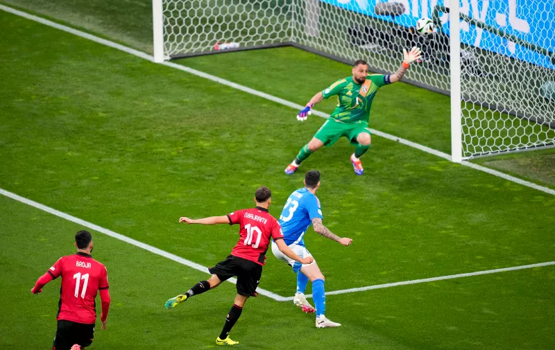 Albania's Nedim Bajrami scores his side's opening goal during a Group B match between Italy and Albania at the Euro 2024 soccer tournament in Dortmund, Germany, Saturday, June 15, 2024. (AP Photo/Andreea Alexandru)