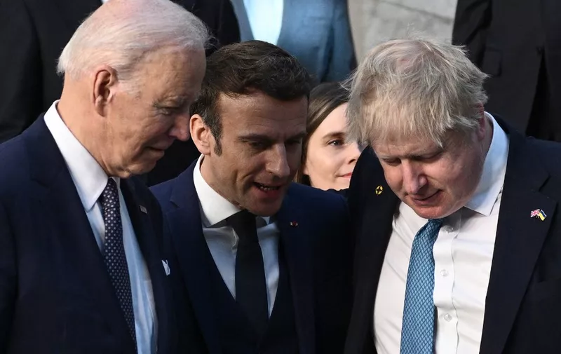 (From R) Britain's Prime Minister Boris Johnson, France's President Emmanuel Macron and US President Joe Biden talk as they arrive at NATO Headquarters in Brussels on March 24, 2022. (Photo by Brendan SMIALOWSKI / POOL / AFP)