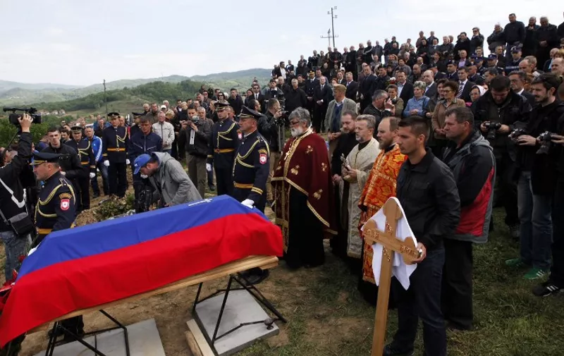People attend the funeral for slain Bosnian police officer Dragan Djuric on April 29, 2015 in Zvornik. Late on April 27, the Zvornik police station was attacked by a man, who opened fire while shouting "Allah Akbar," officials state. Officer Djuric was killed, two more policemen were hospitalised with injuries, and the attacker was killed by officers. Police spokeswoman Aleksandra Simojlovic spoke to reporters, calling it a "terrorist" attack. AFP PHOTO / STRINGER